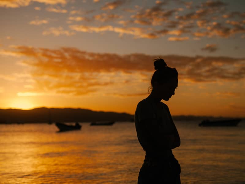 woman with depression against sunset