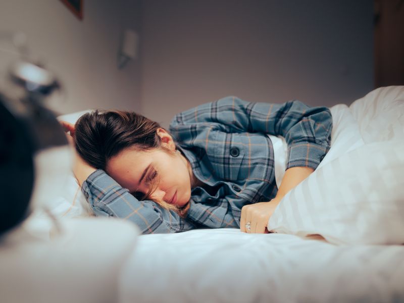 woman lies in bed with terrible fatigue