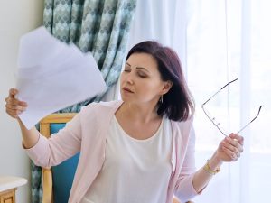 moan fanning her face with a hot flash post hysterectomy