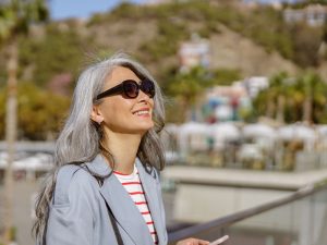 happy, healthy woman outdoors to help illustrate results of hyperbaric oxygen therapy