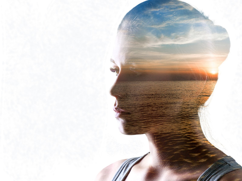 Head and brain of woman filled with healthy landscape image to illustrate brain health