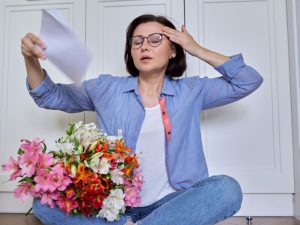 woman experiencing menopausal symptoms like hot flashes
