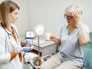 senior woman with doctor in an office to illustrate treating menopausal symptoms with BHRT