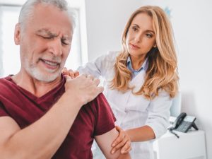 doctor making diagnosis before providing integrative treatment for chronic pain issues