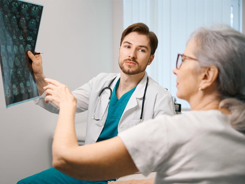 older woman being shown a scan result to illustrate healthy brain aging