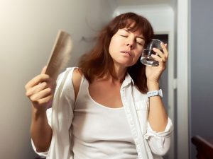 woman cooling down to illustrate hormonal imbalance after hysterectomy