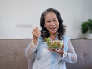 senior woman enjoying a healthy breakfast to contribute to longevity