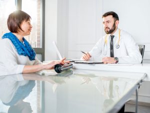 older woman with doctor to illustrate healthcare support for hysterectomy recovery