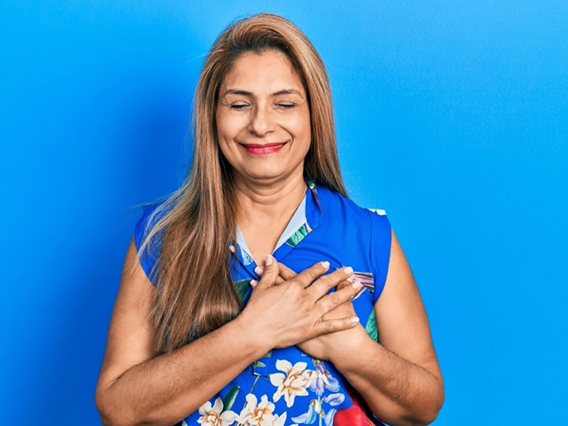 woman smiling in gratitude to illustrate experiencing the benefits of BHRT post menopause