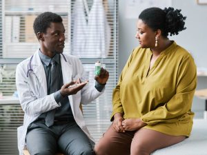 doctor holding bottle of pills to illustrate a hormone discussion