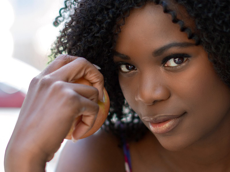 Smiling woman with clear skin to illustrate having solved any hormonal imbalance and skin problems
