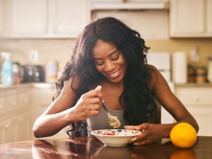 woman eating healthy breakfast to illustrate lifestyle help for PCOS and low libido