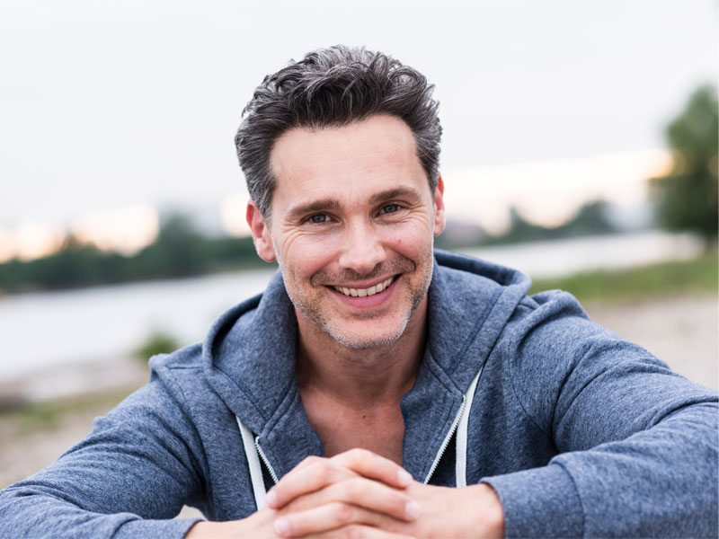 smiling man by river to illustrate benefits of testosterone replacement therapy TRT