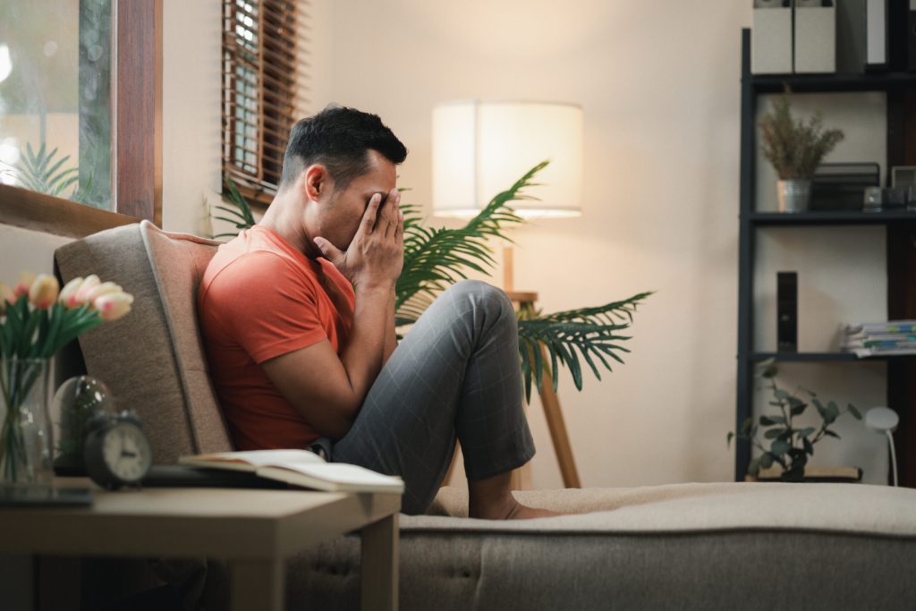 Feeling stressed in the house on the sofa, There is depression due to stress problems in the living room, Become sensitive due to chronic problems at work.