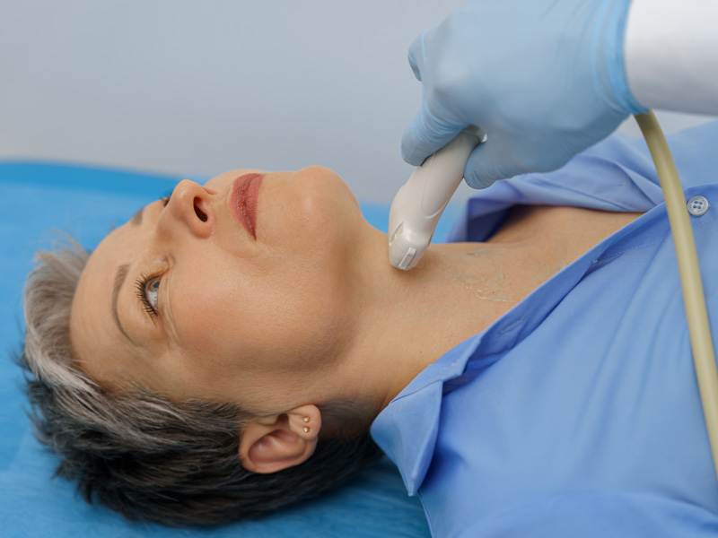 examination of a woman's thyroid gland to illustrate foods to avoid with hypothyroidism