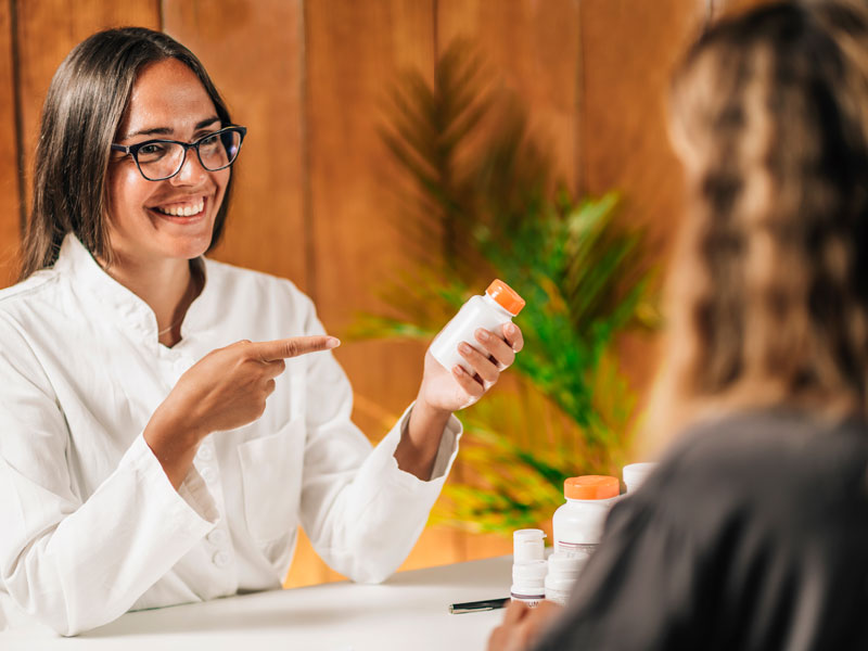 Female practitioner discussing vitamins for hormonal balance with a patient